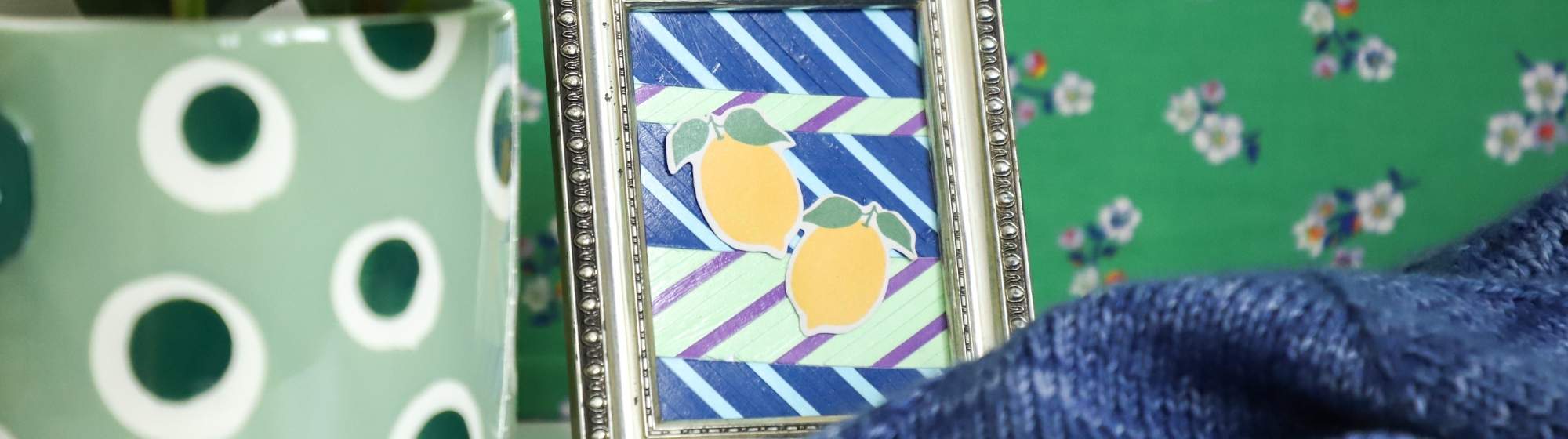Petit cadre décoratif motif citron posé à côté d’une plante dans un univers DIY coloré